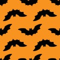 Vector seamless pattern of a black bat silhouette on an orange background for a Halloween packaging design template and background Royalty Free Stock Photo