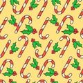 Vector seamless pattern. Candy canes and holly berry. Christmas wrapping paper design. Yellow background