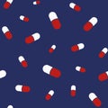Vector seamless pattern with color pills, red and white capsules, isolated on dark blue background Royalty Free Stock Photo