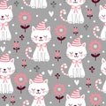 Vector seamless pattern with cute squinted kittens in Christmas caps on a gray background