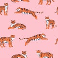 Vector seamless pattern with cute tigers on the pink background