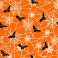 Vector seamless pattern for the Halloween holiday. Cobwebs and bats on an orange background. Horror texture  for party decor. Royalty Free Stock Photo