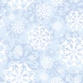 Vector seamless pattern with lacy snowflakes on a gentle blue background. Winter holidays.