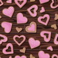 Vector seamless pattern of pink cookies in the shape of hearts isolated on background of wooden table Royalty Free Stock Photo