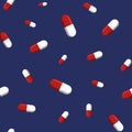 Vector seamless pattern with red and white pills, tablets, isolated on dark blue background Royalty Free Stock Photo