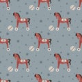 Vector seamless pattern with retro rocking kids toy red horse with ball and stars.