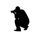 Vector silhouette of a man with a camera on a white background. Royalty Free Stock Photo