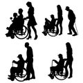 Vector silhouettes of people in a wheelchair. Royalty Free Stock Photo