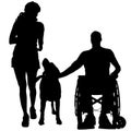 Vector silhouettes of people in a wheelchair. Royalty Free Stock Photo