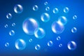 Vector soap bubbles set isolated on blue background. Realistic soap bubbles collection with rainbow and glares Royalty Free Stock Photo