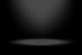 Vector spotlight background. Black gradient shading. Light source above. Dark vignette effect.