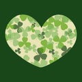 Vector St Patrick's day card. Green and white clover leaves on heart shape and dark background. Royalty Free Stock Photo