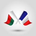 Crossed malagasy and french flags on silver sticks - symbol republic of madagascar and france