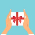 Vector of two female hands holding gift box with red ribbon Royalty Free Stock Photo
