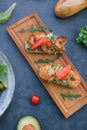 Vediterranean vegetable salad of fresh tomato, olives, capers, onion, spinach, lettuce and sesame on plate. Grillled shrimp Royalty Free Stock Photo