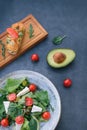 Vediterranean vegetable salad of fresh tomato, olives, capers, onion, spinach, lettuce and sesame on plate. Grillled shrimp Royalty Free Stock Photo