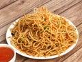 Veg Hakka Noodles a popular oriental dish made with noodles and vegetables, served over a rustic wooden background, selective
