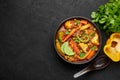 Veg Kolhapuri in black bowl on dark slate table top. Indian vegetable curry dish. Vegetarian asian food and meal Royalty Free Stock Photo