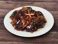 Veg Manchurian, Popular indo-chinese food made of cauliflower florets and other vegetable, served in a white plate over a rustic Royalty Free Stock Photo