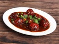 Veg Manchurian, Popular indo-chinese food made of cauliflower florets and other vegetable, served in a white plate over a rustic Royalty Free Stock Photo