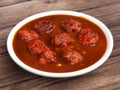 Veg Manchurian, Popular indo-chinese food made of cauliflower florets and other vegetable, served in a white plate over a rustic Royalty Free Stock Photo