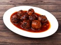 Veg Manchurian, Popular indo-chinese food made of cauliflower florets and other vegetable, served in a white plate over a rustic Royalty Free Stock Photo