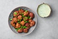 Veg Pakora in gray bowl on concrete table top. Pakoda is indian cuisine appetizer deep fried dish. Asian food and meal