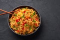 Veg Schezwan Fried Rice in black bowl at dark slate background. indo-chinese cuisine dish