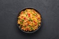 Veg Schezwan Fried Rice in black bowl at dark slate background. indo-chinese cuisine dish Royalty Free Stock Photo