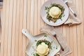 Vegan alternative eggs benedict with plant-based sauce, sourdough bread, tofu, young onion, greens, pea sprouts outside Royalty Free Stock Photo