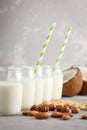 Vegan alternative nut milk in glass bottles on gray background. Royalty Free Stock Photo