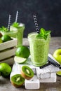 Vegan antioxidant green smoothie, organic cocktail with fresh kiwi fruit, apple, lime and mint, healthy food, vegetarian detox die Royalty Free Stock Photo