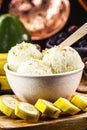 vegan banana ice cream made with frozen bananas and tropical fruits in the background, without adding chemicals. Healthy dessert