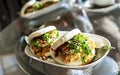 Vegan bao sandwich with tofu and kimchee in a cafe