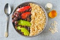 Vegan breakfast bowl of oatmeal, sesame and fruit.