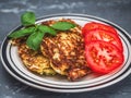 Vegan breakfast with cabbage pancakes and tomatoes and basil close-up on Royalty Free Stock Photo