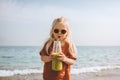 Vegan breakfast child drinking smoothie on beach healthy eating lifestyle