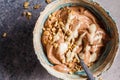Vegan breakfast. Chocolate banana smoothie bowl with granola and nut butter, top view
