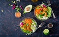 Vegan buddha bowl dinner food table. Healthy food. Healthy vegan lunch bowl. Fritter with lentils and radish, avocado, carrot sala Royalty Free Stock Photo