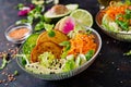 Vegan buddha bowl dinner food table.Healthy vegan lunch bowl. Fritter with lentils and radish, avocado, carrot salad. Royalty Free Stock Photo