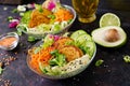 Vegan buddha bowl dinner food table. Healthy vegan lunch bowl. Fritter with lentils and radish, avocado, carrot salad.