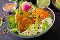 Vegan buddha bowl dinner food table. Healthy vegan lunch bowl. Fritter with lentils and radish, avocado salad Royalty Free Stock Photo