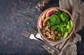 Vegan buddha bowl dinner food table. Healthy food. Healthy vegan lunch bowl. Grilled mushrooms, broccoli, radish salad. Flat lay. Royalty Free Stock Photo