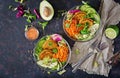 Vegan buddha bowl dinner food table. Healthy food. Healthy vegan lunch bowl. Fritter with lentils and radish, avocado, carrot sala Royalty Free Stock Photo