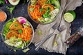 Vegan buddha bowl dinner food table. Healthy food. Healthy vegan lunch bowl. Fritter with lentils and radish, avocado, carrot sala Royalty Free Stock Photo