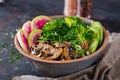 Vegan buddha bowl dinner food table.Healthy vegan lunch bowl. Grilled mushrooms, broccoli, radish salad Royalty Free Stock Photo