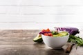 Vegan Buddha bowl with fresh raw vegetables and quinoa on wood Royalty Free Stock Photo