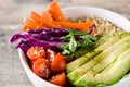 Vegan Buddha bowl with fresh raw vegetables and quinoa on wood Royalty Free Stock Photo