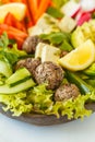 Vegan buddha bowl salad with vegetables, tofu, black beans meatballs and avocado. Healthy vegan food concept.