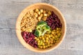 Vegan buddha bowl with stir fry tofu, brown rice, broccoli, red kidney beans, cooked chickpeas, seeds and vegetables. Flat lay. Royalty Free Stock Photo